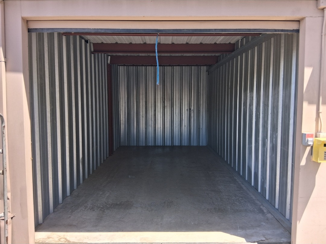 Garage storage unit empty and swept clean after junk removal
